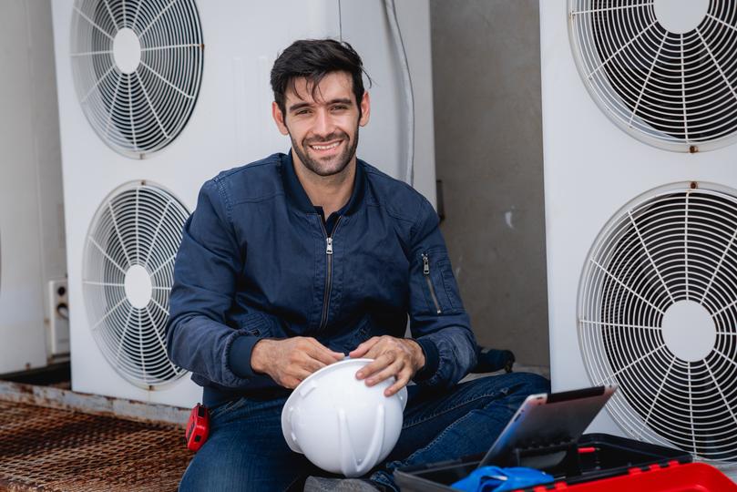 An HVAC technician servicing an air conditioning unit